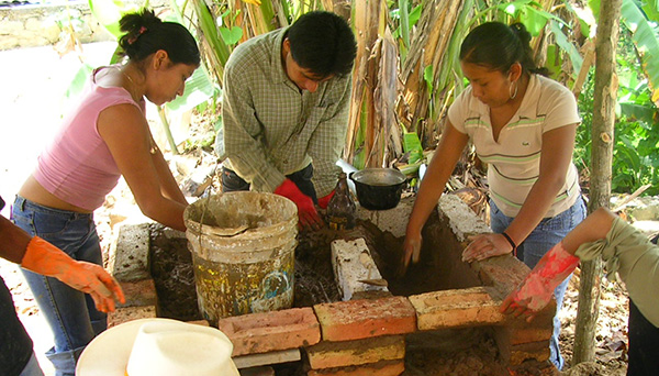 People building a furnace with their hands